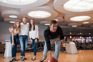 Smiling friends. Young cheerful people have fun in bowling club at their weekends photo