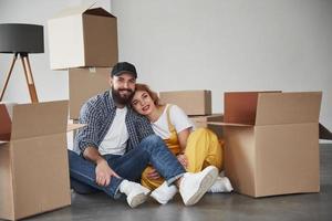 Dreamy look. Happy couple together in their new house. Conception of moving photo