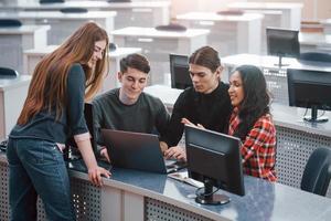 Active conversation. Group of young people in casual clothes working in the modern office photo