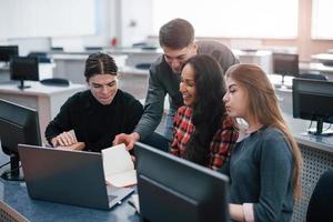 Group of young people in casual clothes working in the modern office photo