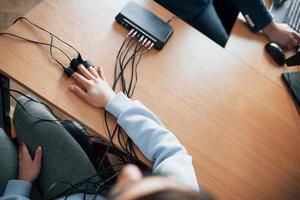 Top view. Girl passes lie detector in the office. Asking questions. Polygraph test photo