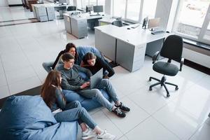 Need to look closer. Group of young people in casual clothes working in the modern office photo