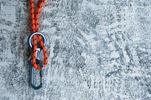 Knot with metal carabiner. Silver colored device for the active sports photo