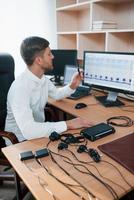 Vertical photo. Polygraph examiner works in the office with his lie detector's equipment photo