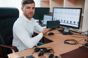 Many monitors. Polygraph examiner works in the office with his lie detector's equipment photo