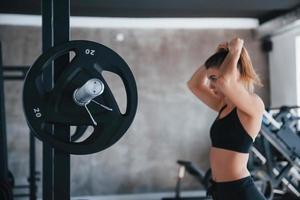 Just one moment. Photo of gorgeous blonde woman in the gym at her weekend time