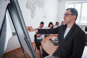 Teaching process. Group of people at business conference in modern classroom at daytime photo