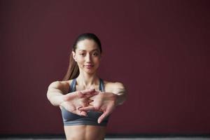 Focused photo. Girl with good fitness body type have exercises in the spacey room photo