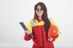 Okay, I'm ready to work. Brunette woman in orange and yellow uniform stands against white background in the studio photo
