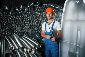 Well done. Man in uniform works on the production. Industrial modern technology photo