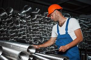 Need to make sure that is everything I calculate is right. Man in uniform works on the production. Industrial modern technology photo