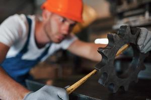 Measuring tape. Man in uniform works on the production. Industrial modern technology photo