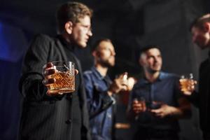 Conception of nightlife. People have fun in the club. With alcohol in hands photo