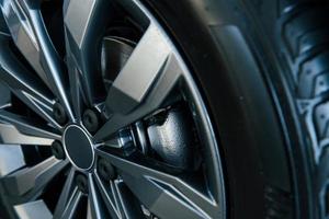 Detailed view of wheel of modern new car. Silver colored discs photo