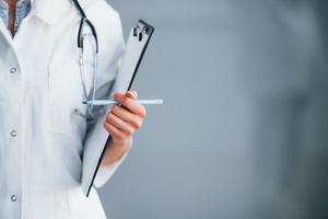 Close up view of young nurse that indoors in modern clinic. Conception of healthcare photo