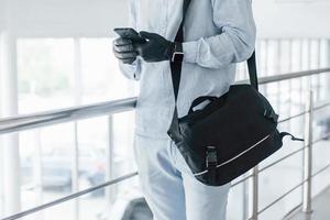 Close up view of young handsome man in formal clothes that indoors in the office at daytime photo