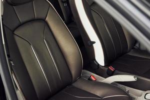 Inside of brand new modern electrical car. Particle view. Cropped photo
