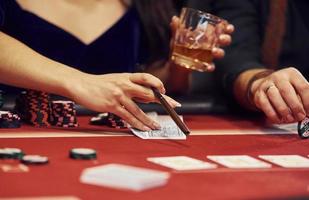 Close up view of elegant young people's hands that playing poker in casino photo