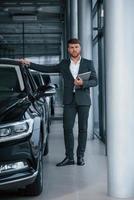 Full length photo. Modern stylish bearded businessman in the automobile saloon photo