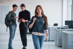 I have good feel about today's deal. Group of young people walking in the office at their break time photo