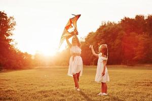 Launching a kite. Mother and daughter have fun in the field. Beautiful nature photo