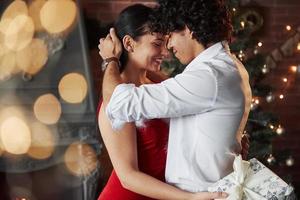 Smiling to each other with eyes shut. New Year's evening dancing. Lovely gorgeous couple spending time together photo