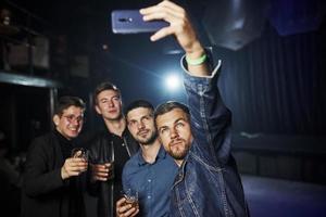 People have fun in the night club. With alcohol in hands photo