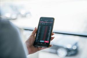 Close up view of phone holding by woman with business and exchange information photo