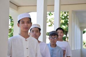 Young southeast asian children standing in a row in front of balcony and waiting to do their daily activity, soft and selective focus. photo