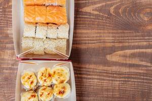 Food delivery rollsHot and cold rolls with salmon, rice, Philadelphia cheese and other ingredients photo