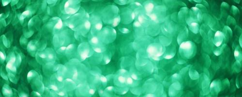 Green abstract background defocus lights round. Blurry glitter background. photo