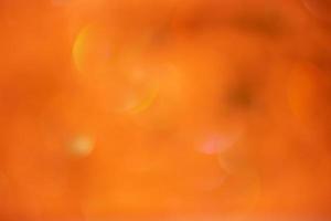 Orange glitter background defocus light. Round defocuses on a blurred background. photo