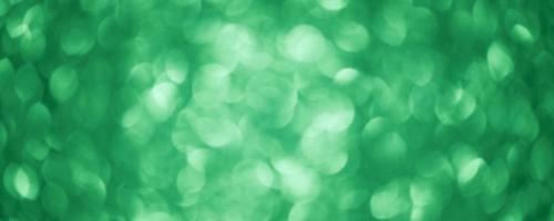 Green glitter background defocus light. Round defocuses on a blurred background. photo