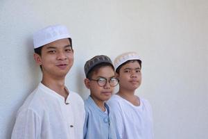 Young southeast asian children standing in a row in front of balcony and waiting to do their daily activity, soft and selective focus. photo