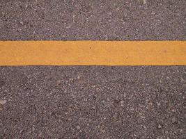 The asphalt and yellow line flat lay image for background or texture concept photo