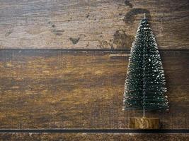 Christmas tree on wood table for holiday concept photo