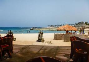 view from the lounge to the sandy beach at the red sea on vacation photo