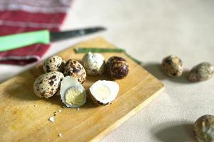 sliced quail eggs on a cutting board on a white background photo