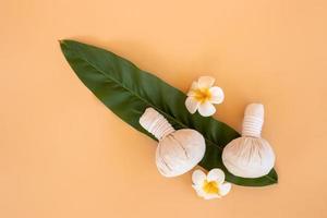 Top view of herbal compress ball with Thai herbal and flower candle. spa background concept. photo