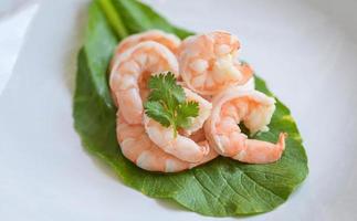 cooked shrimps prawns for seafood with herb cannabis leaf and coriander, cooking boiled shrimp, Fresh shrimp on fresh vegetables photo