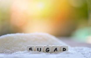 Sugar on nature blur background, white sugar for food and sweets dessert candy heap of sweet sugar crystalline granulated photo