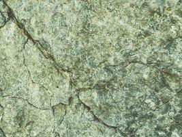 mountain texture. volumetric 3d background with a rock of stones and sand. rock with holes and burrows. solid stone, natural materials background photo