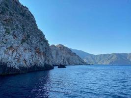 Beautiful view of the blue sea and high rocky mountains in a tourist tropical country for vacation photo