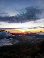 beautiful sunset on top marapi mountain with beautiful sky clouds photo