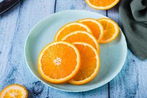 Fresh juicy sliced orange on a plate on the table. Healthy food. photo