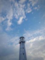 Defocused abstract blurred of white minaret of Mosque in Lombok Island, Indonesia, on the background of blue sky with white clouds. photo