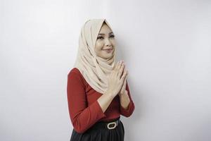 Portrait of a young beautiful Muslim woman wearing a hijab gesturing Eid Mubarak greeting photo