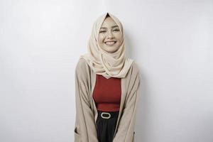 Portrait of a confident smiling Asian Muslim woman standing and looking at the camera isolated over white background photo