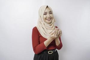 Happy beautiful Asian Muslim girl wearing a headscarf praying to God. photo