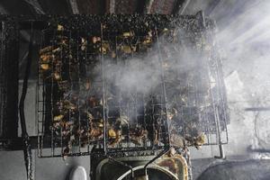 A portrait of grilled ribs on smokey barbeque pit photo